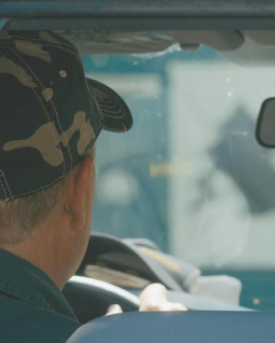 man in hat driving